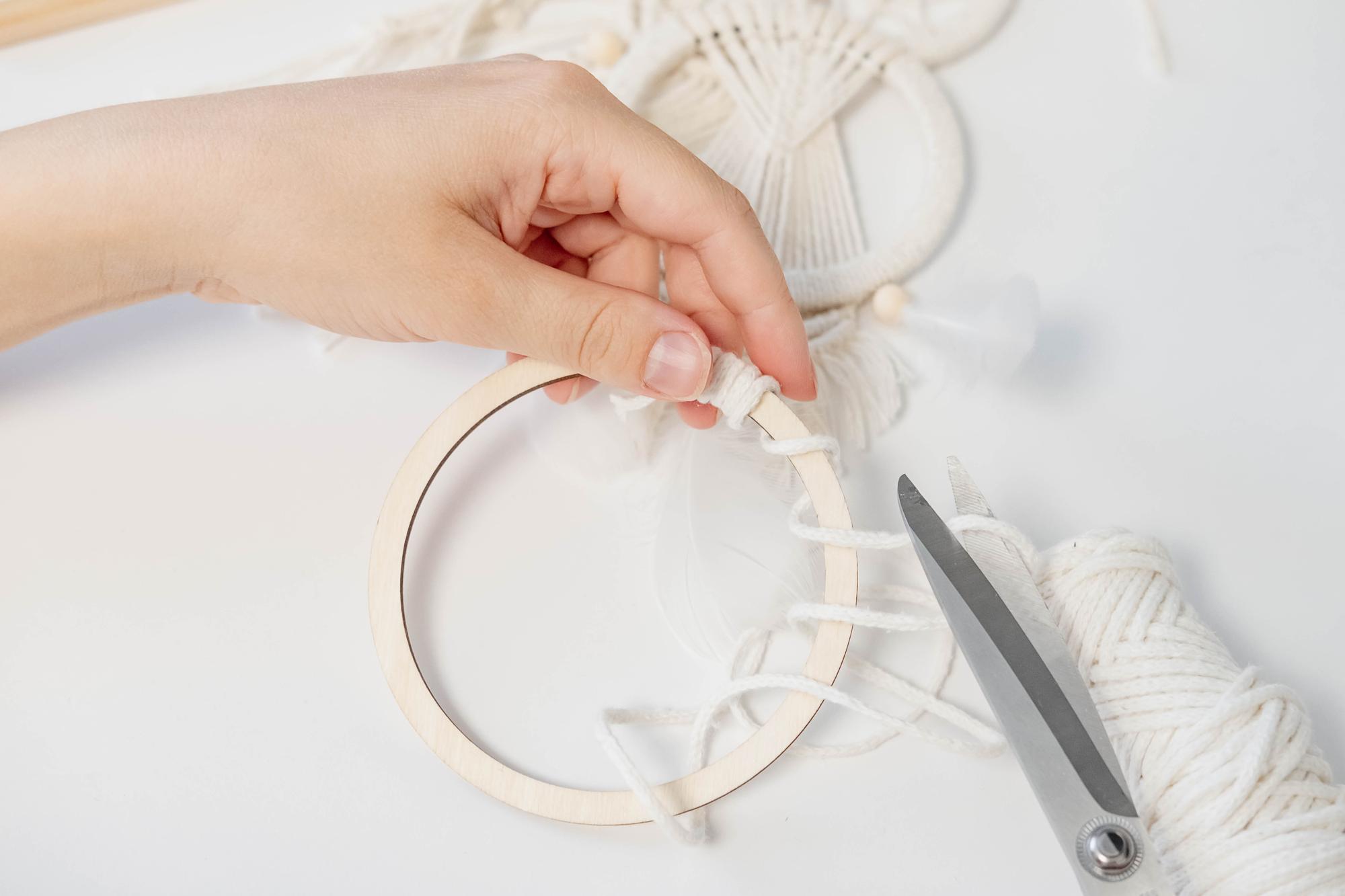 Woman stitching floral embroidery hoop in studio